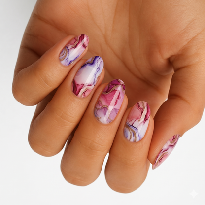 Pink and purple marble nail wraps with gold veining on an almond shape