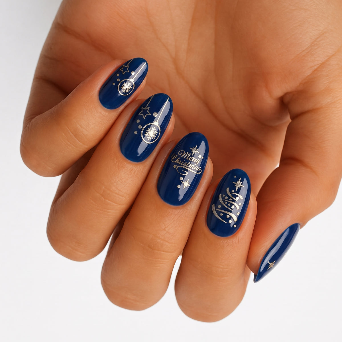 Navy blue glossy nail wraps with gold stars, baubles and "Merry Christmas" lettering