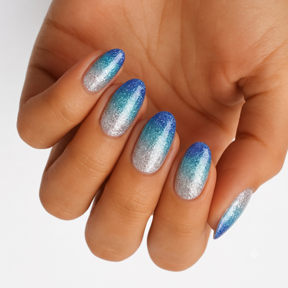 Glittery nail wraps in blue-to-silver ombré with icy teal gradient, almond shape