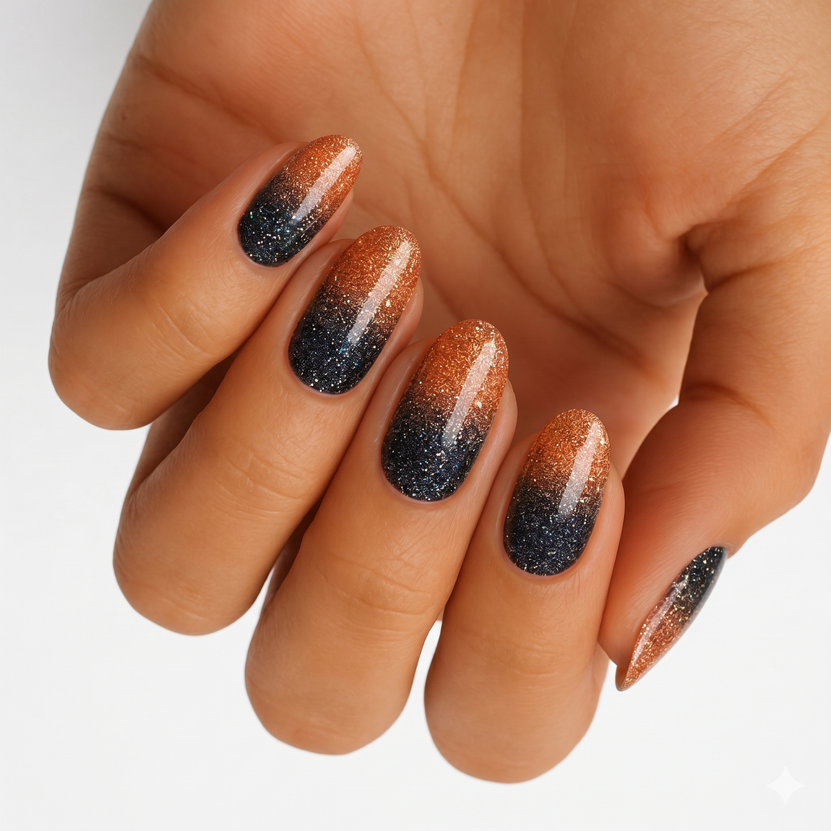Orange-to-black glitter ombré nail wraps with shimmer finish on an almond shape.