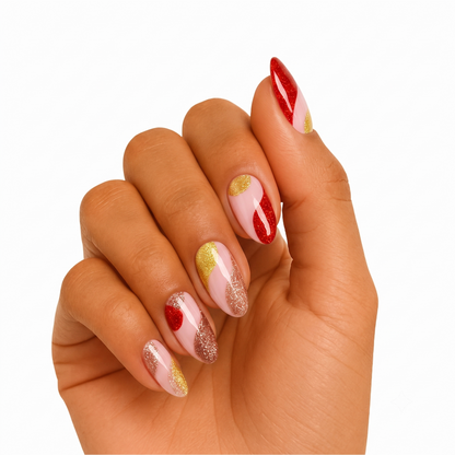 Nail wraps in glossy nude with red and gold glitter abstract swirl accents
