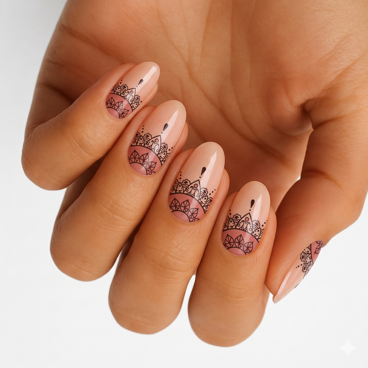 Nude nail wraps with black henna-style mandala lace design at the base, glossy finish