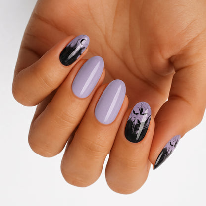 Lilac and black nail wraps with bat silhouettes and speckled Halloween-inspired design, glossy finish.