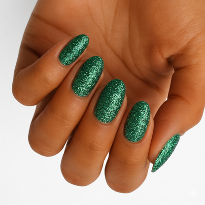 Emerald green glitter nail wraps on almond-shaped nails, full sparkle finish.