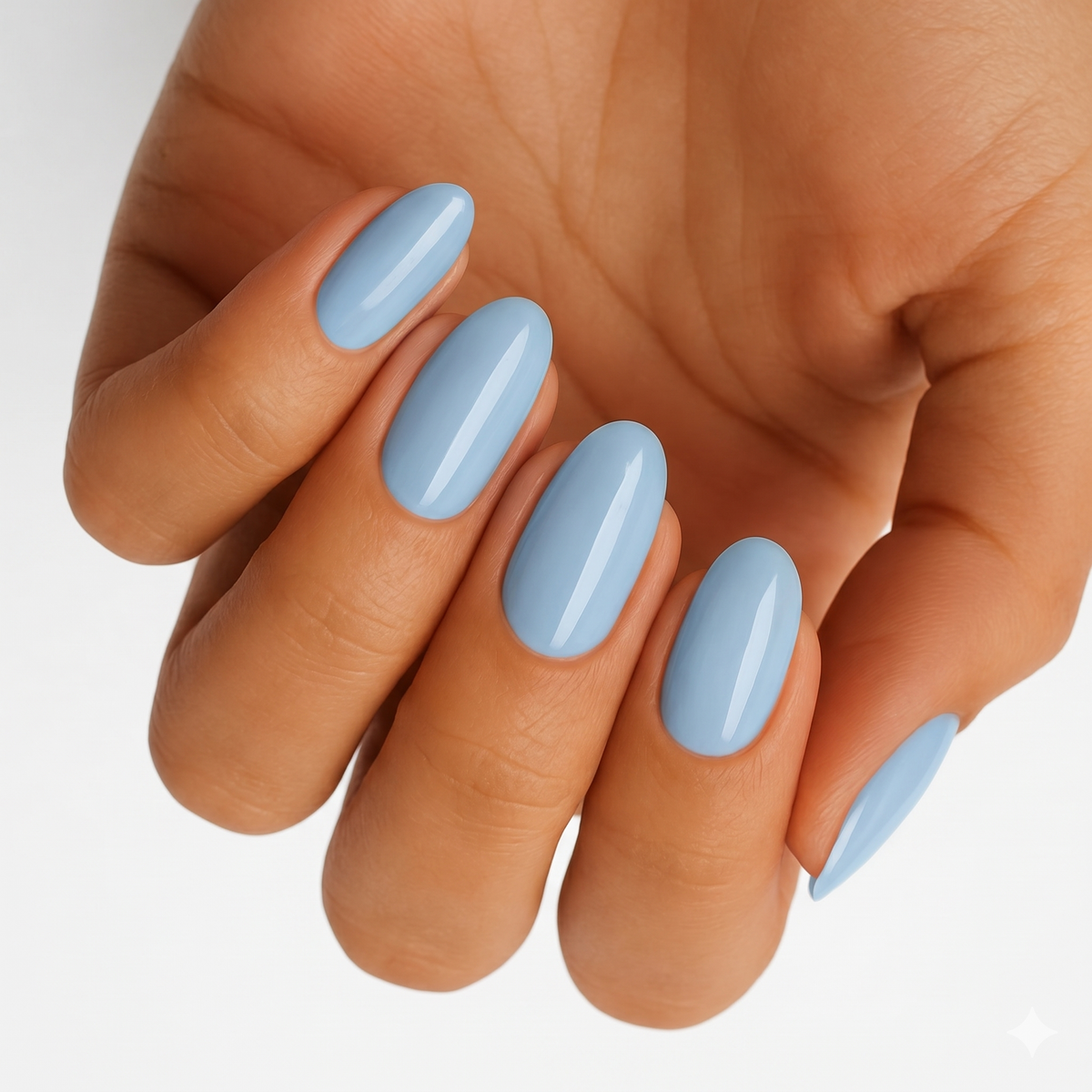 Solid pale blue glossy nail wraps on almond-shaped nails
