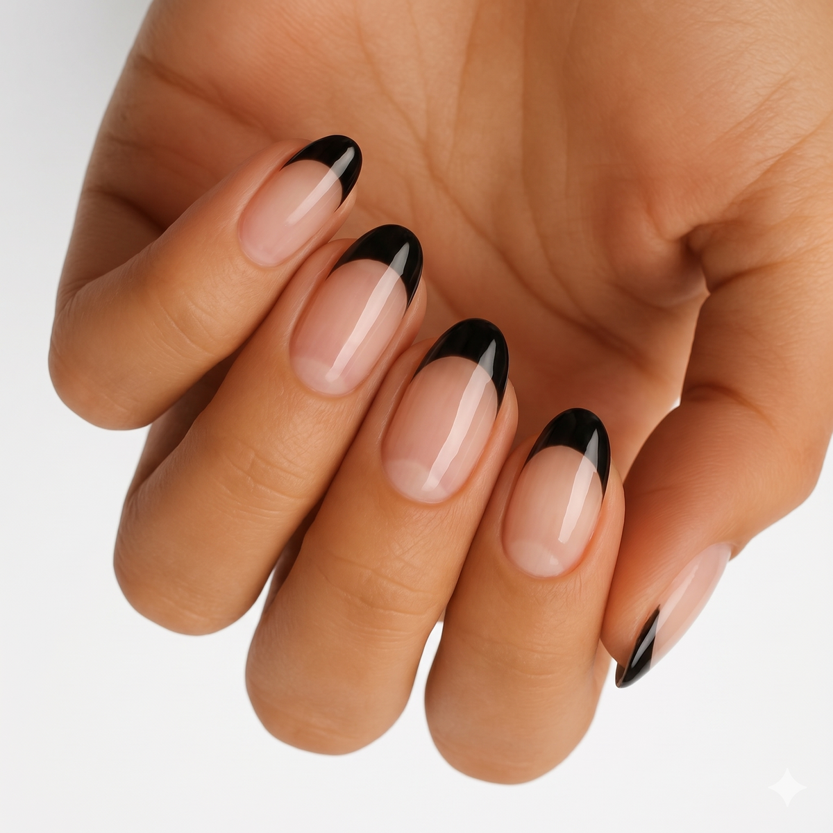 Glossy black French tip nail wraps on a sheer nude base, almond shape