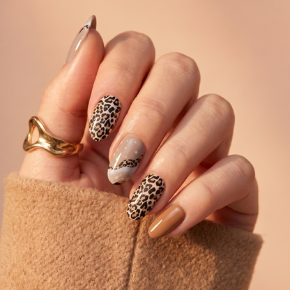 Glossy nail wraps in leopard print, nude, grey swirl and caramel brown shades on almond nails