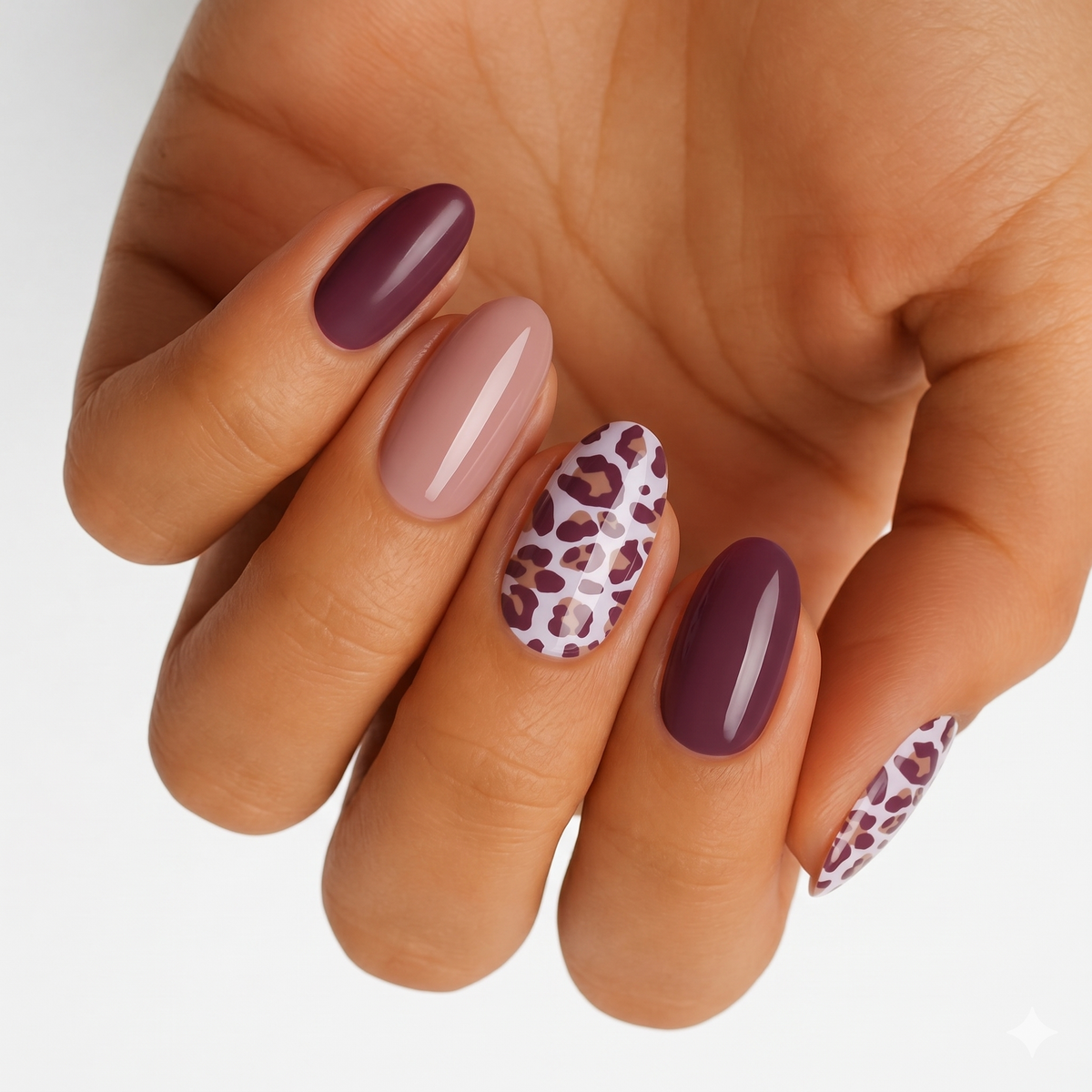 Glossy nail wraps in plum, dusty pink, and leopard print on an oval set