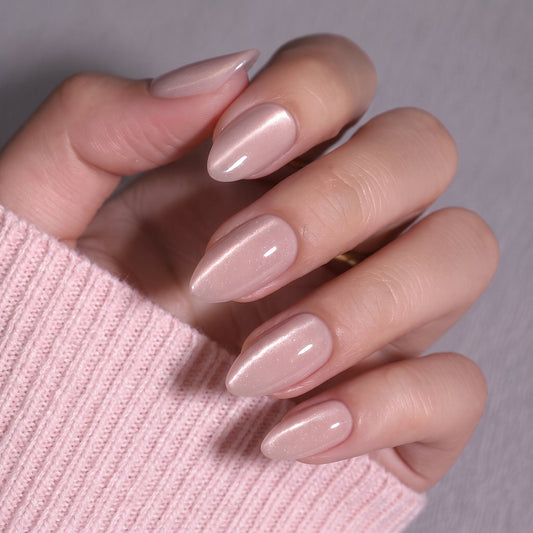 Sheer nude pink almond press-on nails with soft shimmer, glossy finish