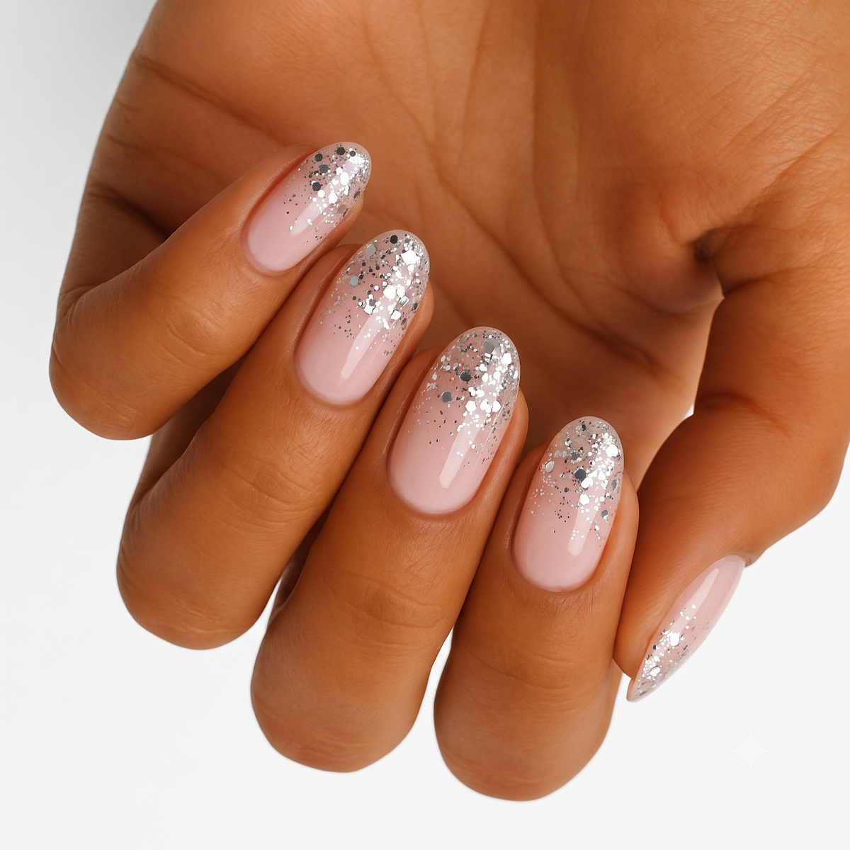 Nude nail wraps with chunky silver glitter fading from the tips