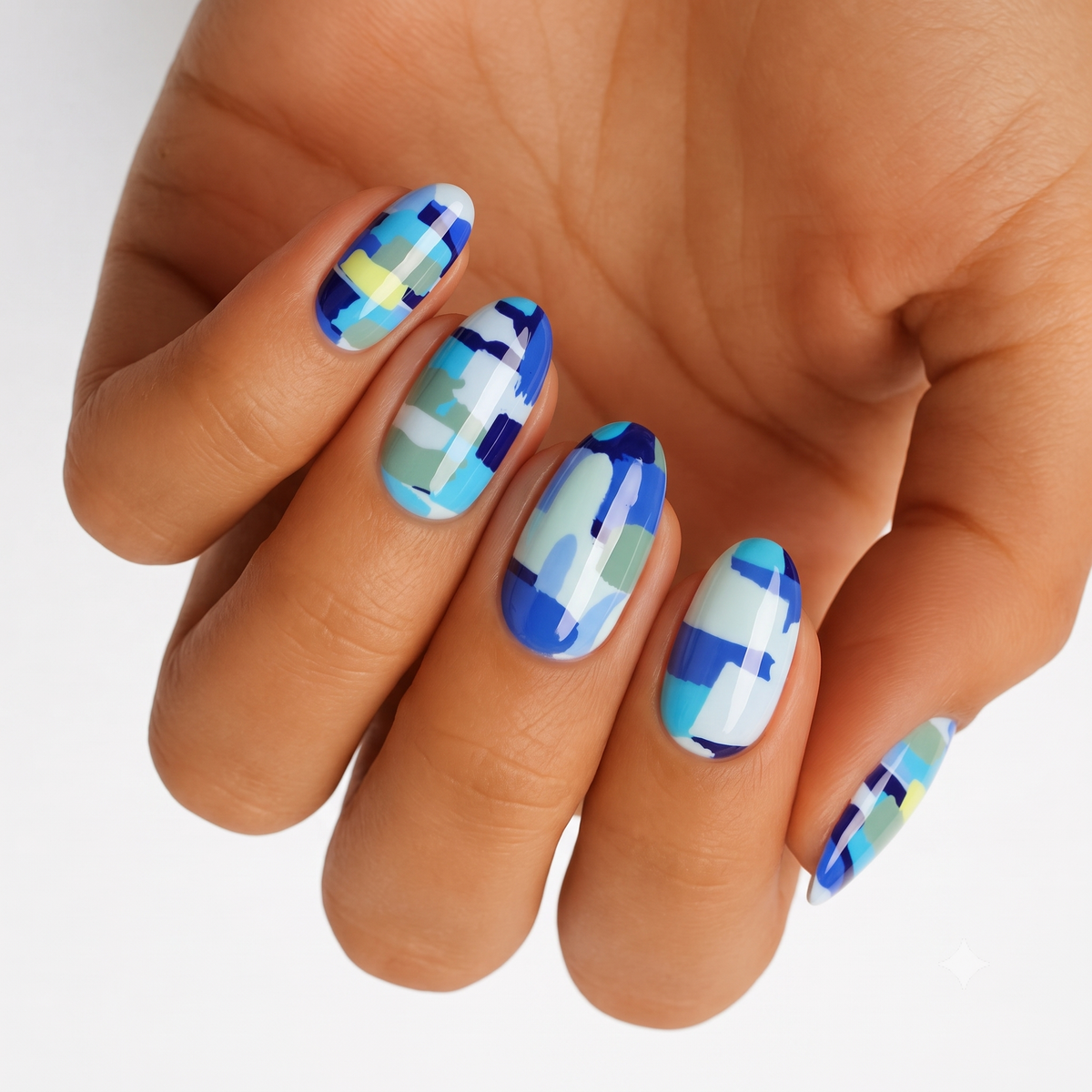 Blue camo nail wraps with abstract blocks in cobalt, sage, and pale yellow tones