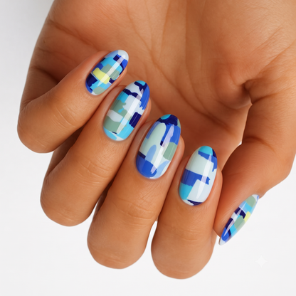 Blue camo nail wraps with abstract blocks in cobalt, sage, and pale yellow tones