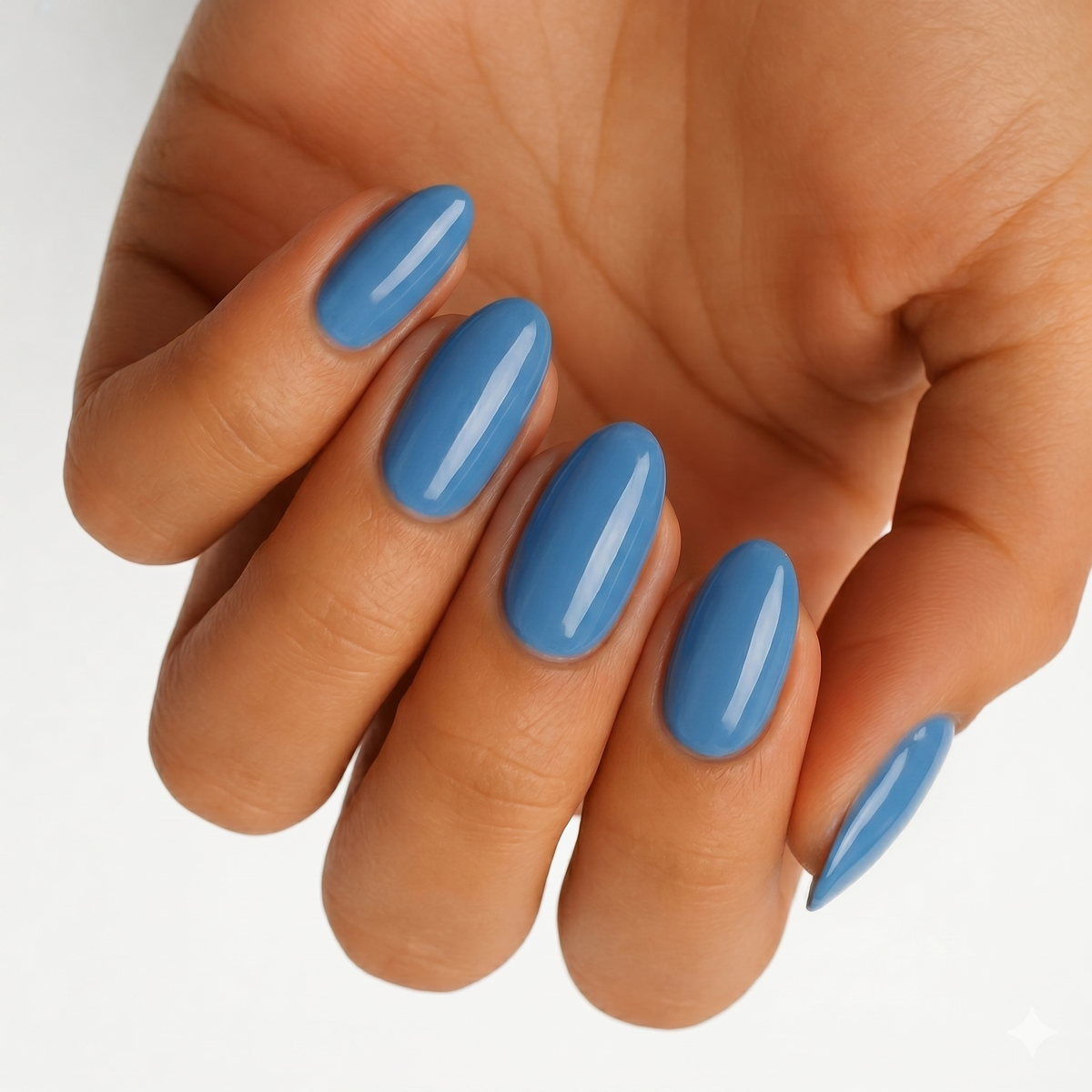 Denim blue glossy nail wraps in a solid colour on almond-shaped nails