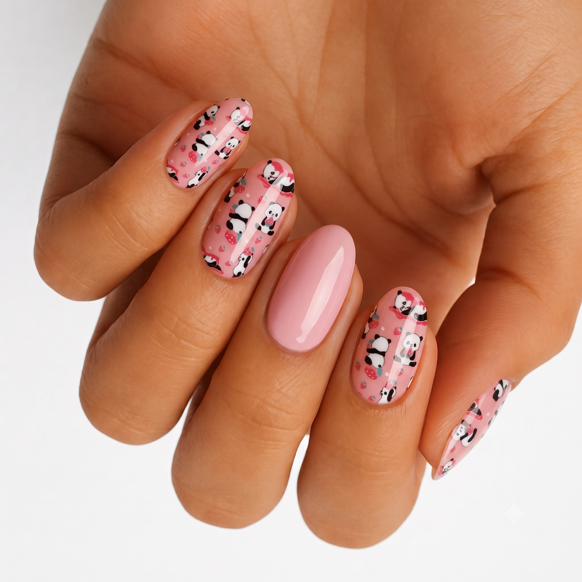 Pink nail wraps with cartoon panda and strawberry print, one plain glossy pink accent nail