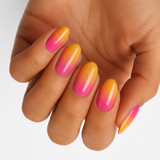 Glossy nail wraps with pink-to-orange sunset ombré on almond-shaped nails