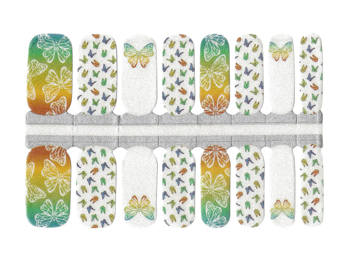 Nail wraps with orange-to-teal ombré butterflies on white glittery base
