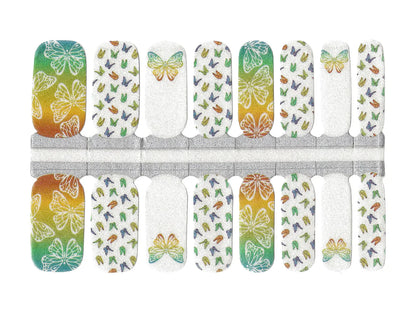 Nail wraps with orange-to-teal ombré butterflies on white glittery base