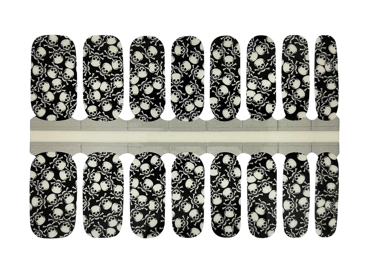 Black nail wraps with white skull and crossbones print, glossy finish, full nail coverage