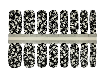 Black nail wraps with white skull and crossbones print, glossy finish, full nail coverage