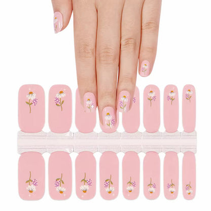 Pink nail wraps with daisy and lilac floral accents, glossy finish