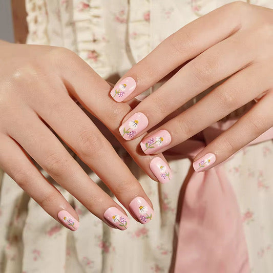 Sheer pink glossy nail wraps with hand-painted daisy and lavender floral accents