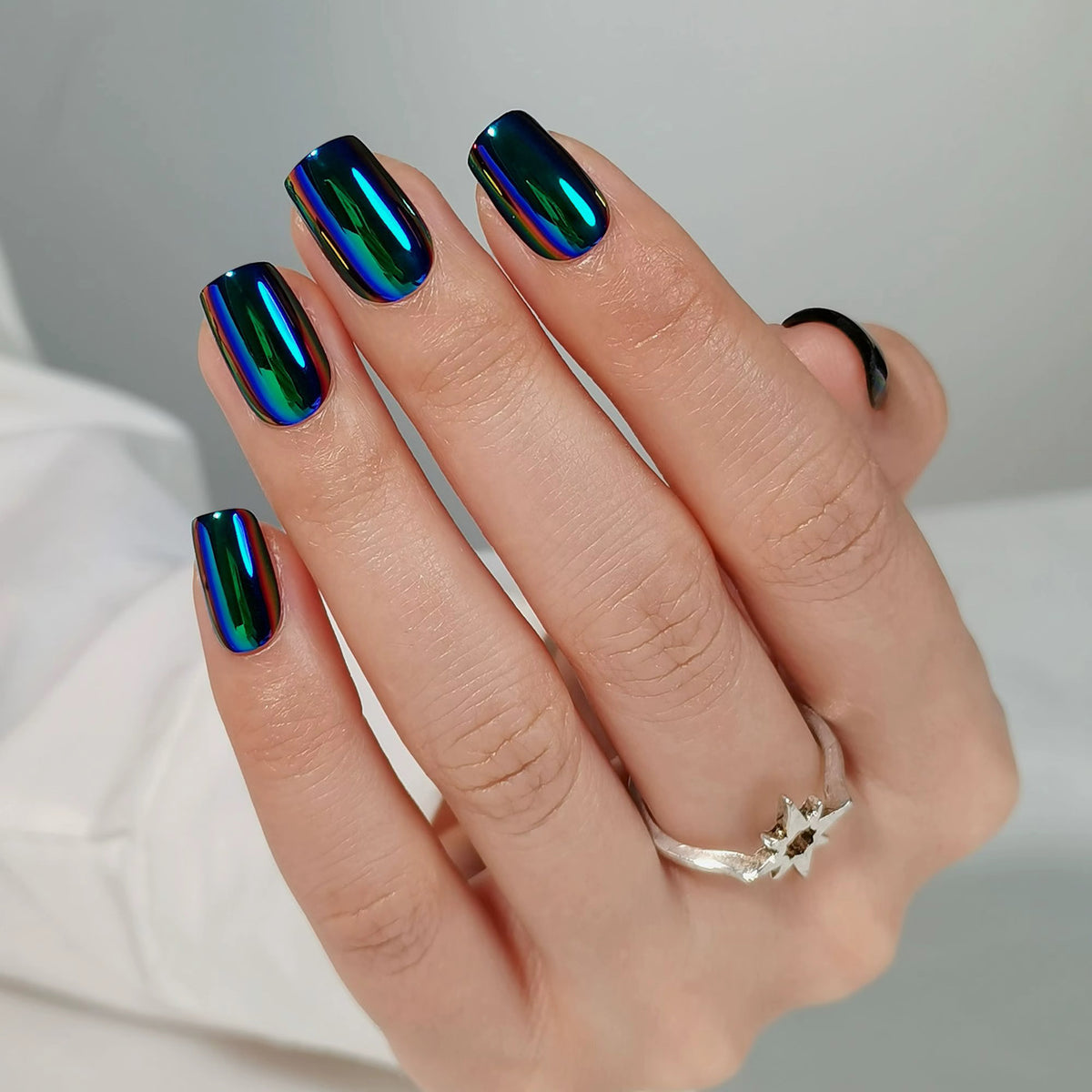 Oil-slick chrome press-on nails, black base with blue-green iridescent metallic finish