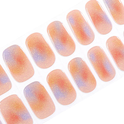 Semi-cured gel nail wraps in coral, orange and lilac watercolour tie-dye with gold shimmer