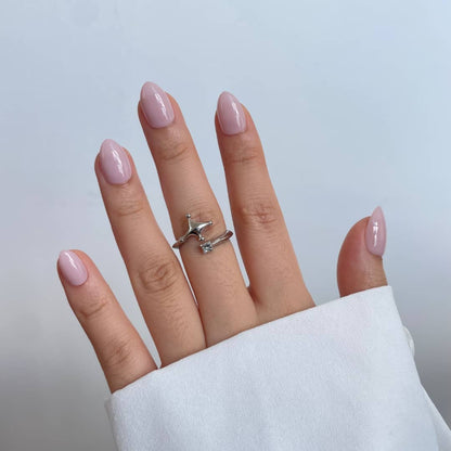 Soft gel press-on nails in sheer milky pink, glossy finish, short almond shape