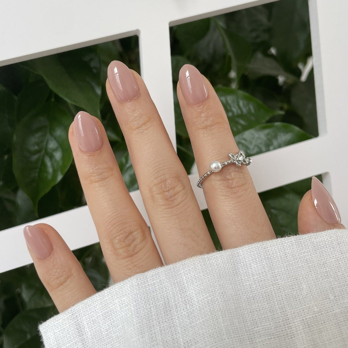 Extra short almond soft gel press-on nails in glossy mauve-pink nude shade