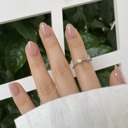 Extra short almond soft gel press-on nails in glossy mauve-pink nude shade
