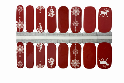 Red glossy nail wraps with white snowflakes, swirled trees, and reindeer Christmas design