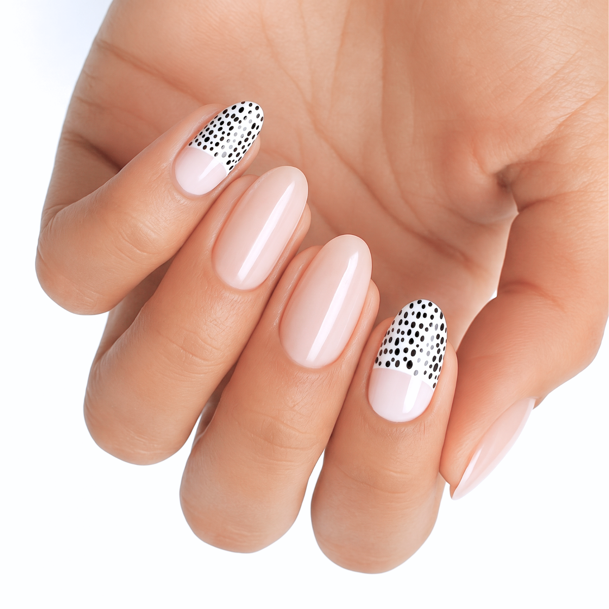 Glossy nude nail wraps with black and white polka dot French tip accent nails
