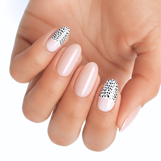 Glossy nude nail wraps with black and white polka dot French tip accent nails