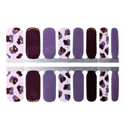 Purple leopard print nail wraps with solid plum and lavender accents, gold foil details.