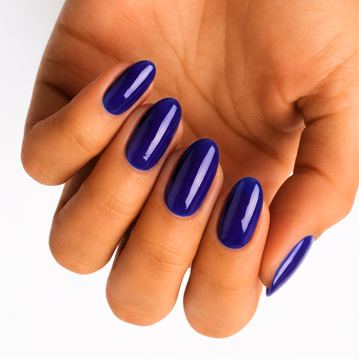 Glossy royal blue nail wraps in a solid gloss finish on almond-shaped nails.