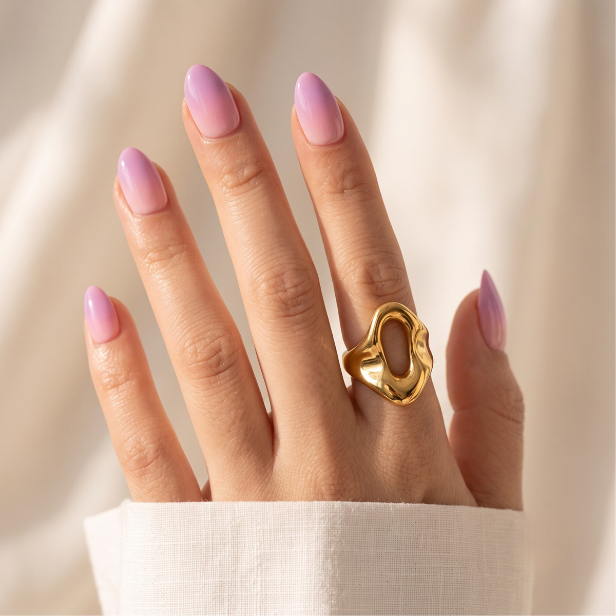Soft gel press-ons in sheer lilac with glossy finish on short almond-shaped nails