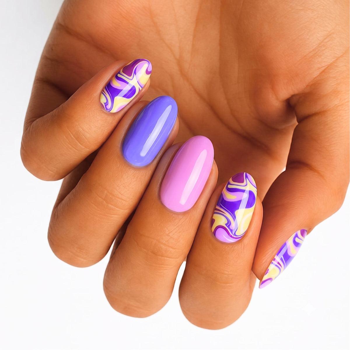 Glossy nail wraps in purple, lilac and pink with swirled purple-yellow marble accent nails