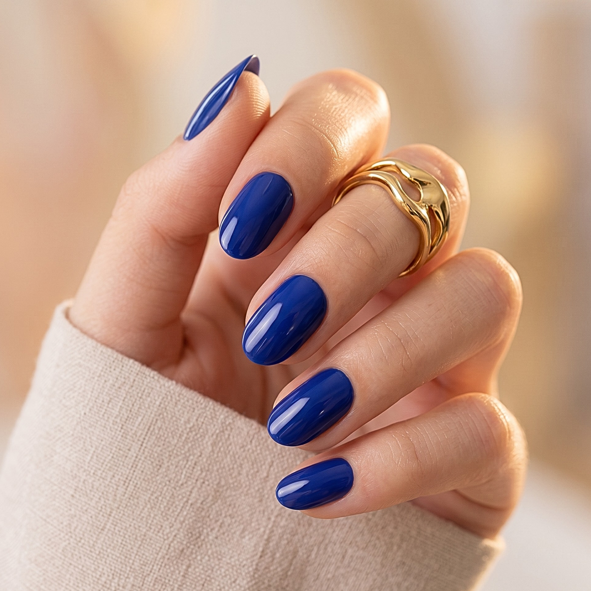Glossy navy blue soft gel press-on nails in a short oval shape