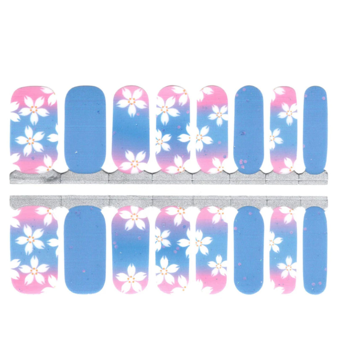 Nail wraps in pink-to-blue ombré with white flower accents and plain blue nails