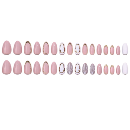 Glossy pink press-on nails with gold outlines, white accents, and shimmer shell details