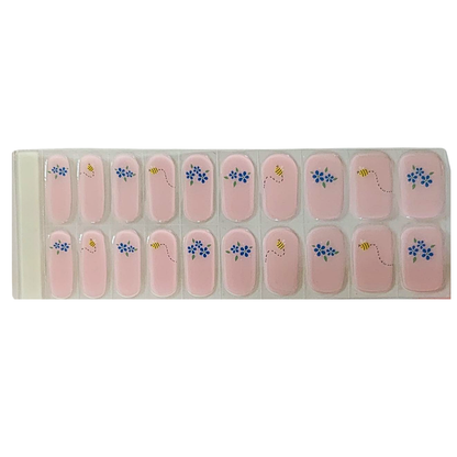 Pink semi-cured gel nail wraps with blue florals and bee accents