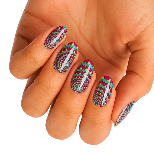 Nail wraps with magenta, teal, and yellow zigzag chevron pattern and spiral center design.