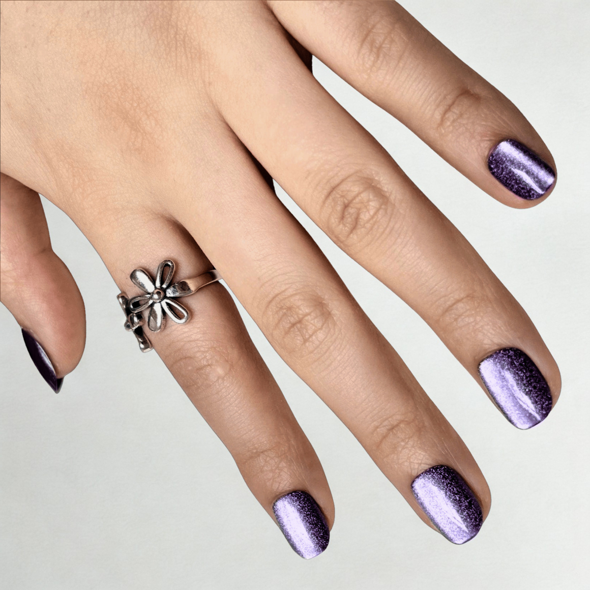 Extra short natural-shaped soft gel press-ons in shimmering purple cat's eye finish