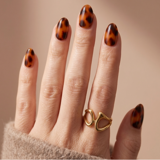 Soft gel press-on nails in glossy amber tortoiseshell print, XS almond shape