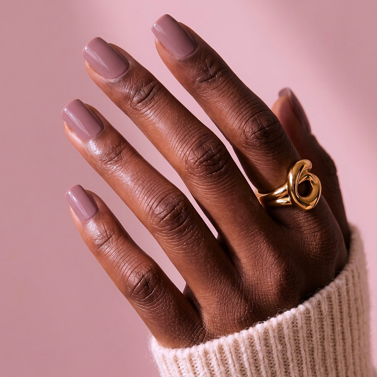 Mauve-taupe glossy soft gel press-on nails, short square shape, on model's hand