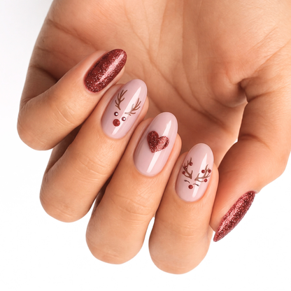 Nude nail wraps with reindeer face design, glitter heart accent and red glitter tips