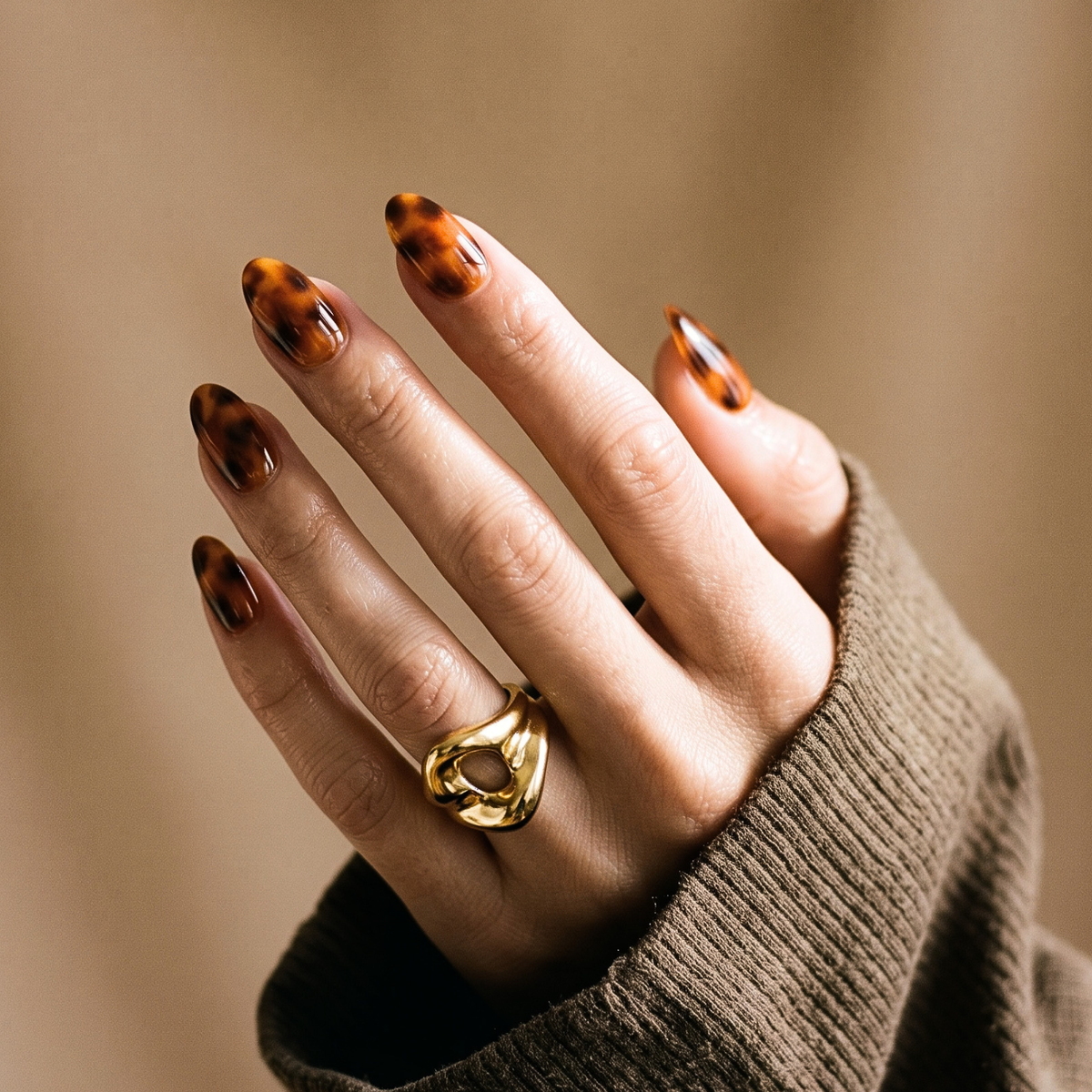 Almond soft gel press-on nails in glossy amber tortoiseshell pattern, extra short length.