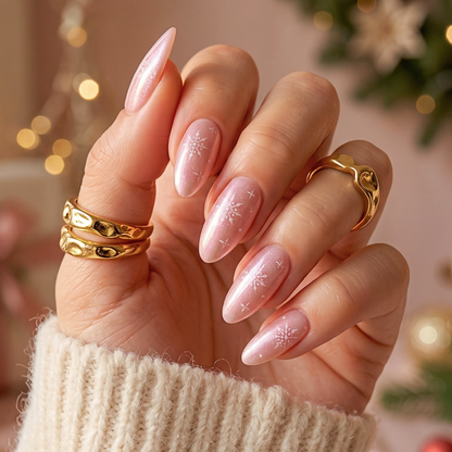Soft gel press-on nails, sheer pearl pink with shimmer and white snowflake design, almond shape