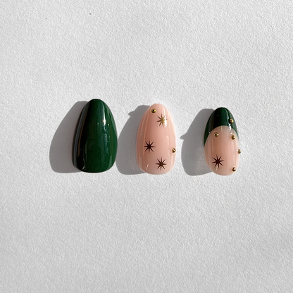 Short almond soft gel press-ons, dark green and nude nails with star accents and gold studs