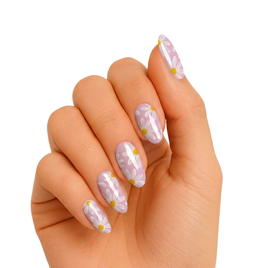 Lavender glossy nail wraps with white daisy flowers and yellow centers.
